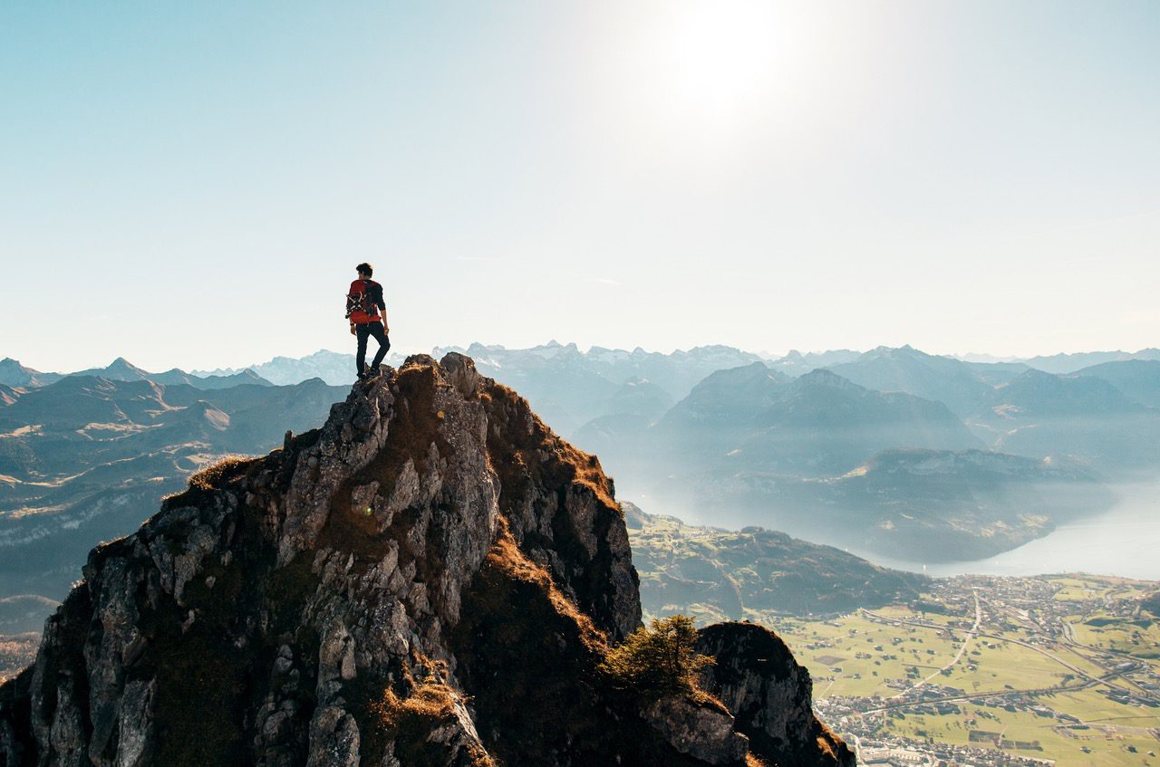 web developer standing on top of mountain