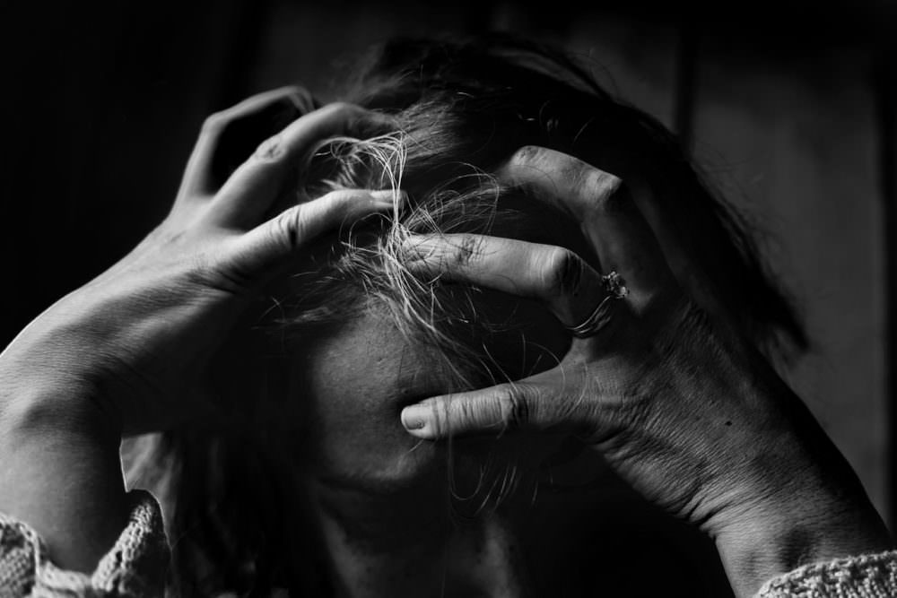 frustrated woman pulling at hair