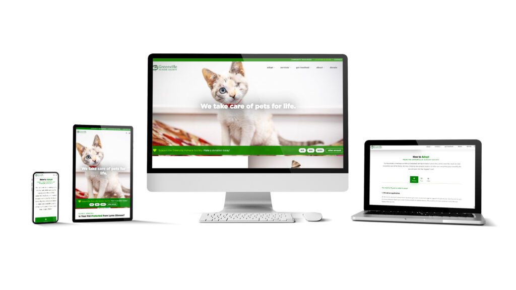A graphic of the Greenville Humane Society website displayed on an iphone, tablet, laptop, and desktop computer. The screens show the Greenville Humane homepage featuring a white cat with a red collar and the tagline "we take care of pets for life." A prominent call to action asking for donations is also displayed on the Greenville Humane Society home screen. 